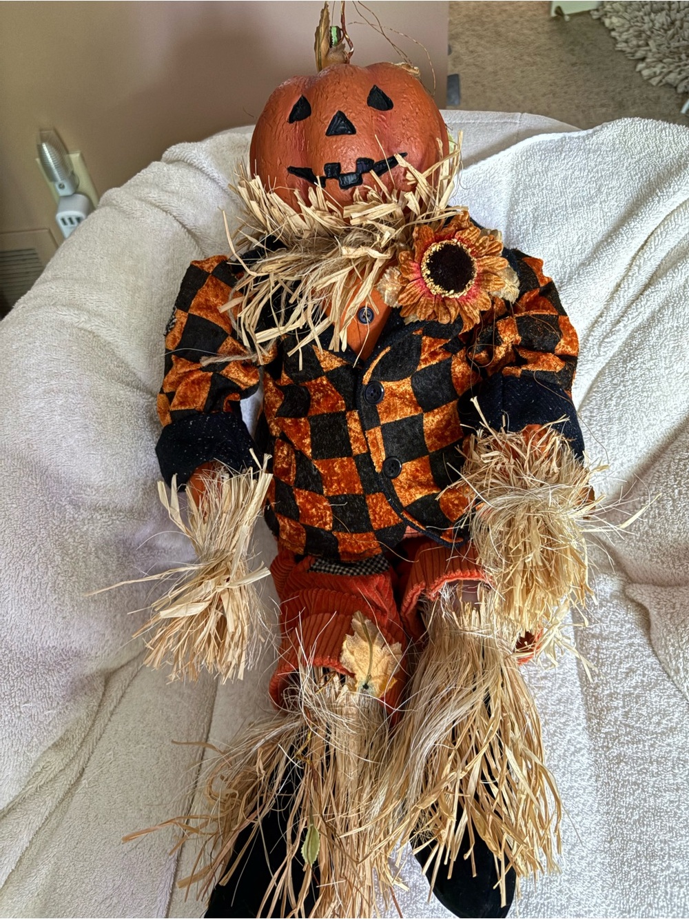 Cute resin head pumpkin doll with checkered jackets, cords, & straw accents.